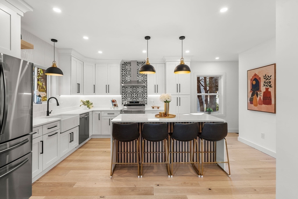 45 Charles Street Wakefield, MA 01880 - Photo 1 of 42 a kitchen with stainless steel appliances granite countertop a sink a stove a refrigerator and island