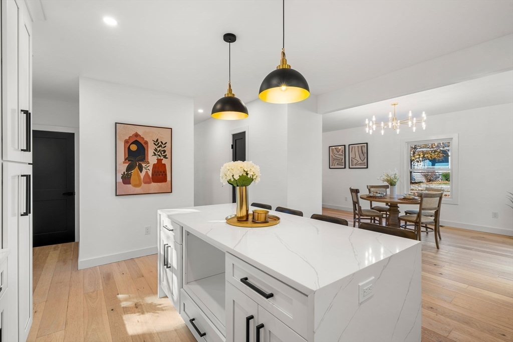 45 Charles Street Wakefield, MA 01880 - Photo 11 of 42 a kitchen with a refrigerator a stove and wooden floor