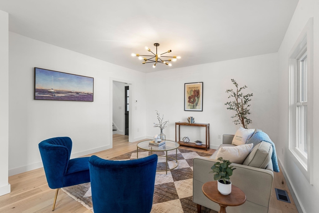 45 Charles Street Wakefield, MA 01880 - Photo 15 of 42 a living room with furniture and a chandelier