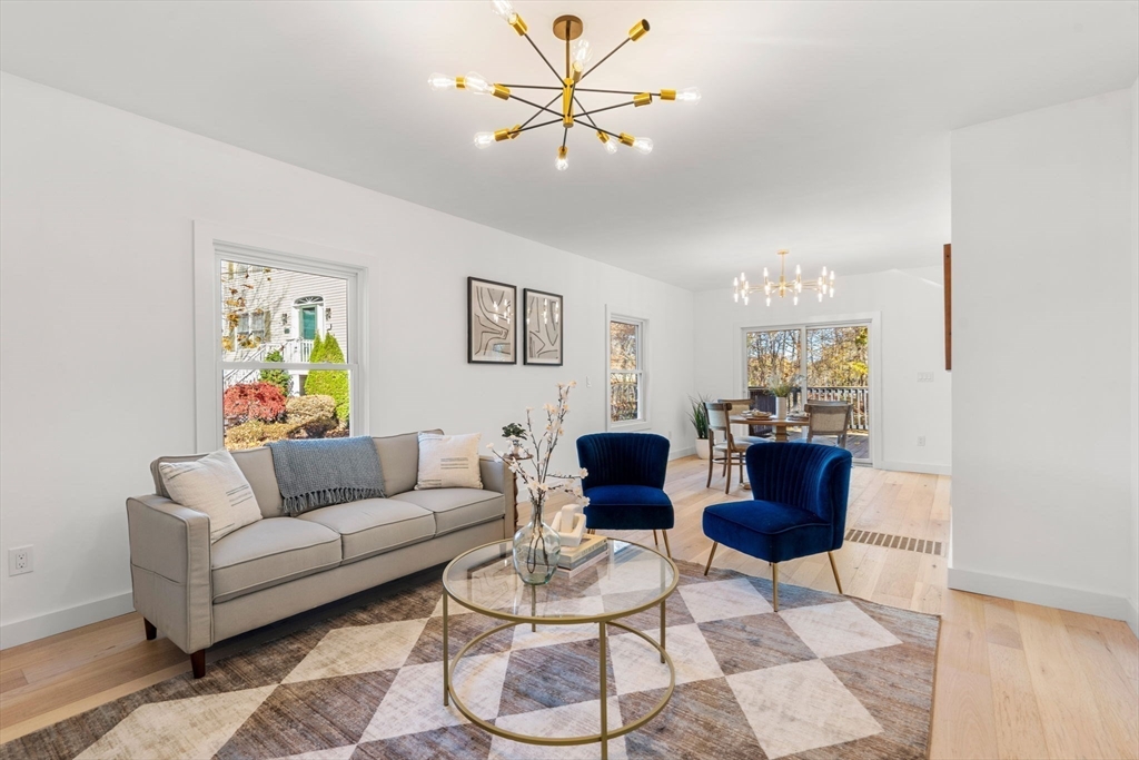 45 Charles Street Wakefield, MA 01880 - Photo 17 of 42 a living room with furniture a chandelier and a window