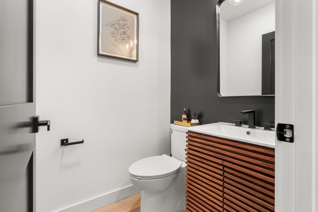 45 Charles Street Wakefield, MA 01880 - Photo 19 of 42 a bathroom with a sink a toilet and a mirror