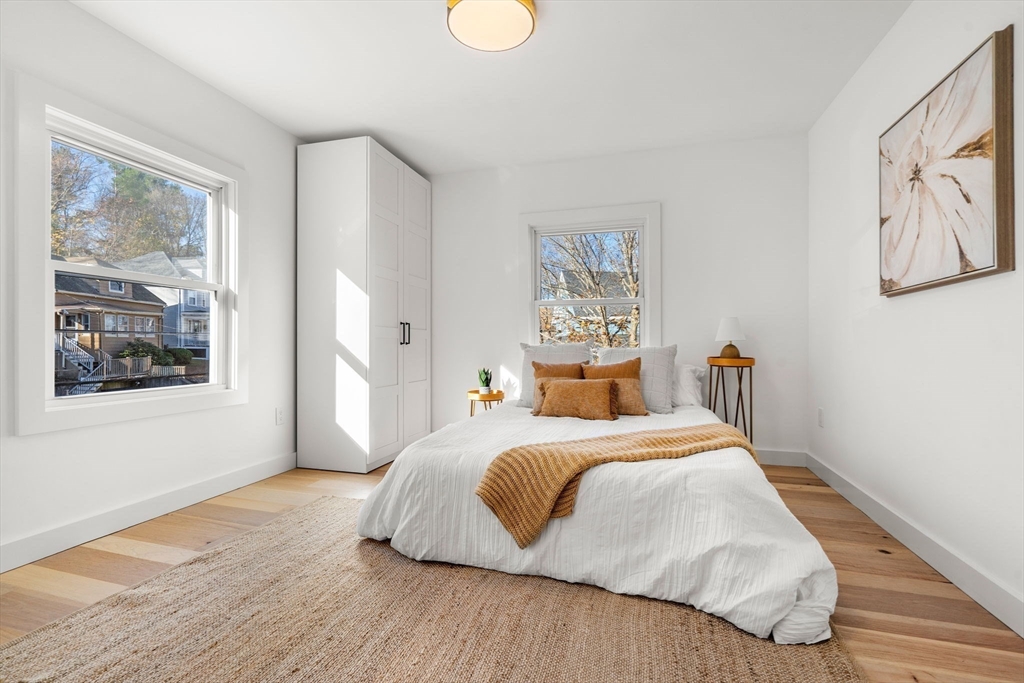 45 Charles Street Wakefield, MA 01880 - Photo 23 of 42 a bedroom with a large bed and a window