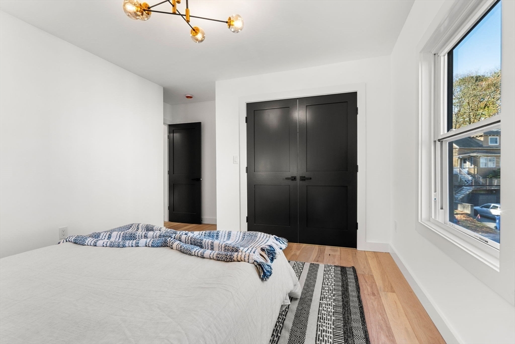 45 Charles Street Wakefield, MA 01880 - Photo 28 of 42 a bedroom with a bed and a painting on the wall