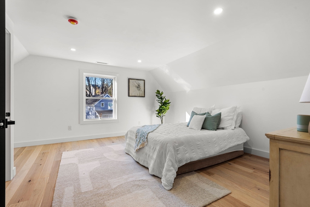 45 Charles Street Wakefield, MA 01880 - Photo 33 of 42 a bedroom with a bed and a painting on the wall