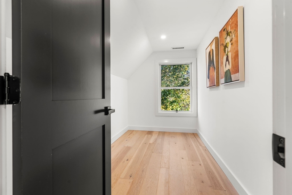 45 Charles Street Wakefield, MA 01880 - Photo 35 of 42 a view of hallway with a large window and a wooden floor