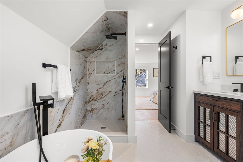 45 Charles Street Wakefield, MA 01880 - Photo 38 of 42 a bathroom with a granite countertop shower sink vanity and toilet