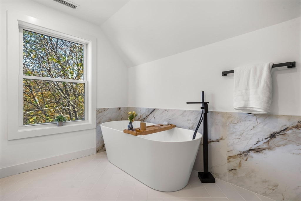 45 Charles Street Wakefield, MA 01880 - Photo 39 of 42 a white bath tub sitting in a bathroom