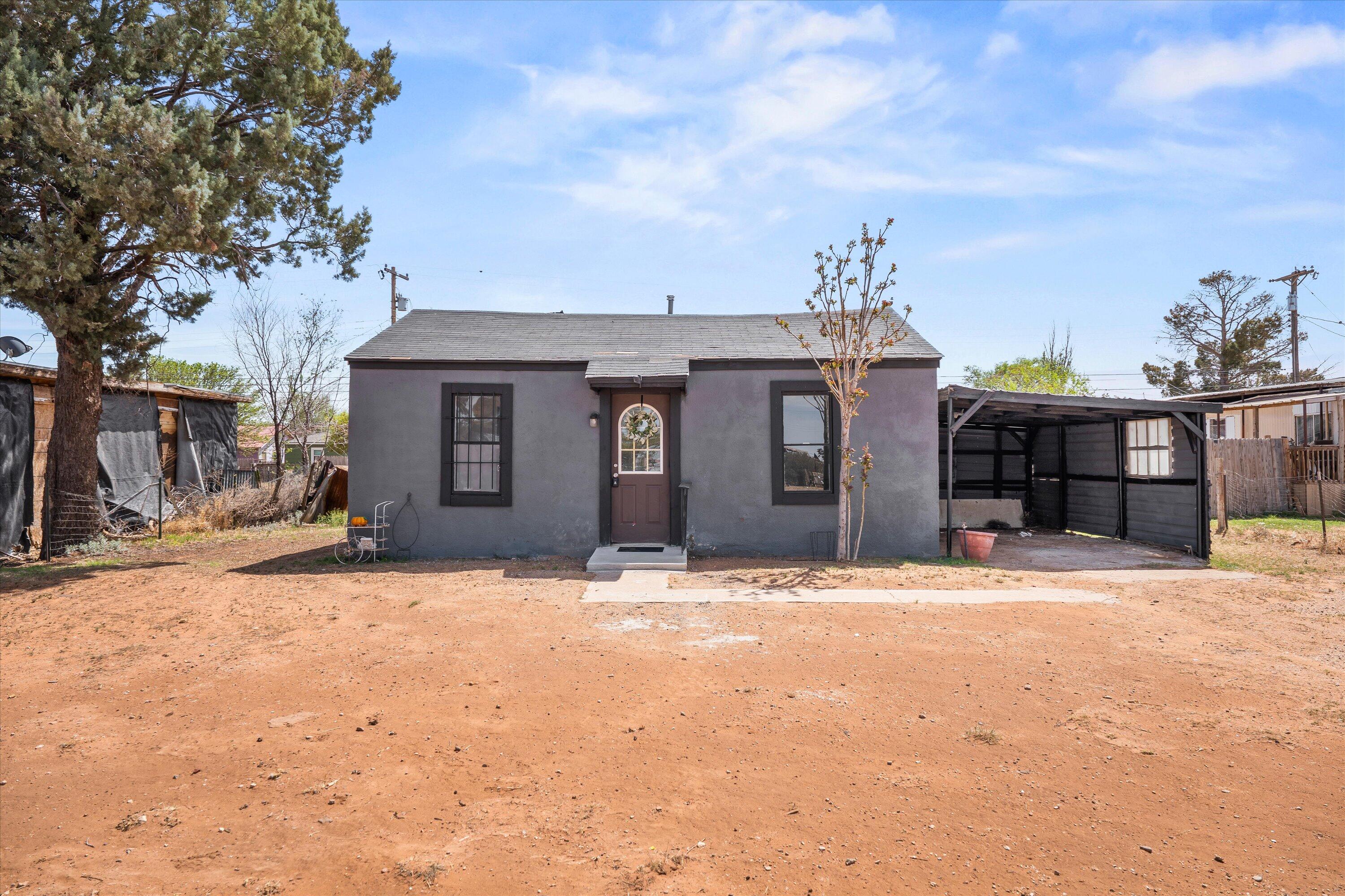 1848 8th Street Levelland, TX 79336 - Photo 1 of 6 a front view of a house with a yard and garage
