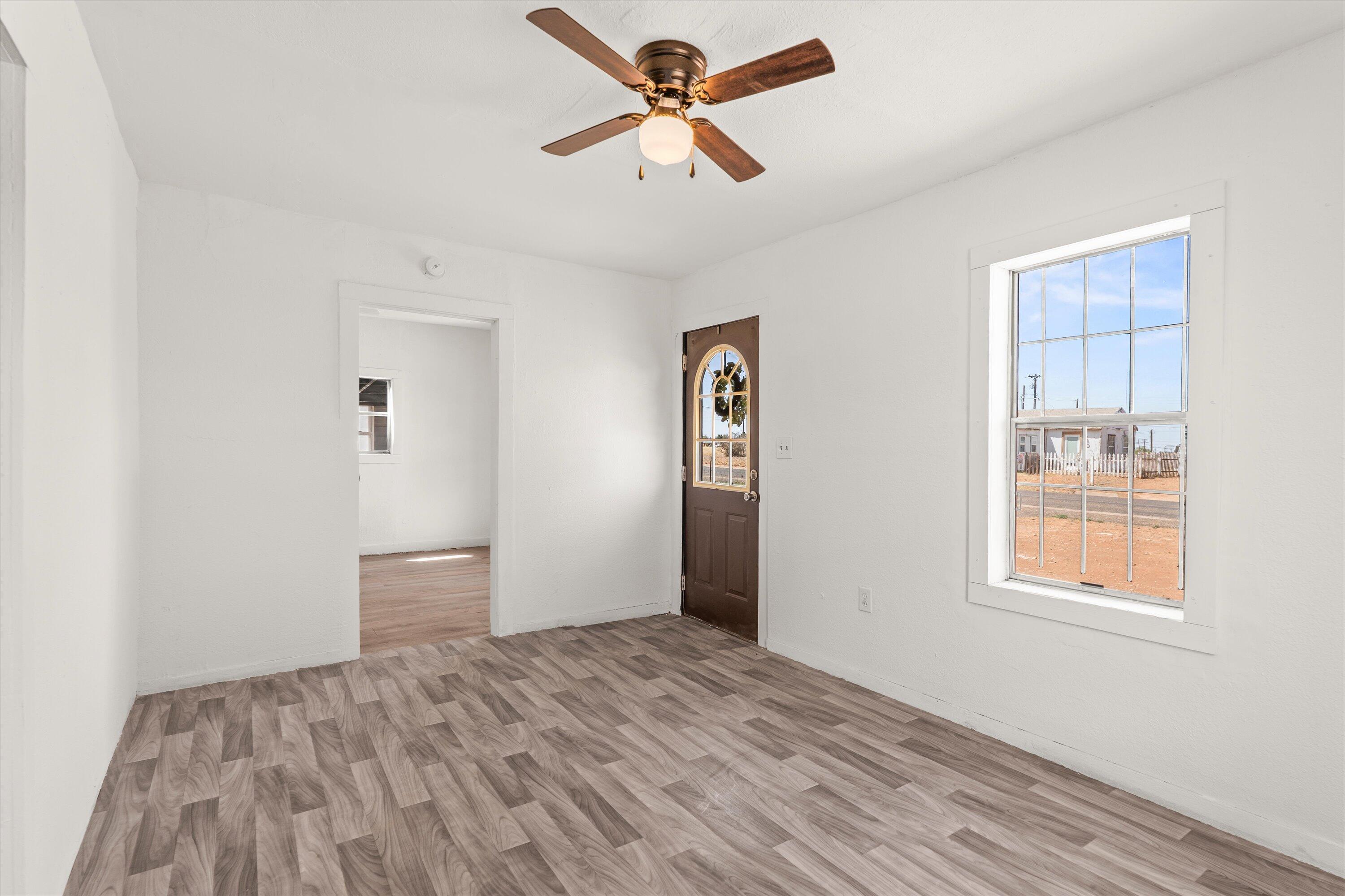 1848 8th Street Levelland, TX 79336 - Photo 2 of 6 a view of empty room with window and ceiling fan