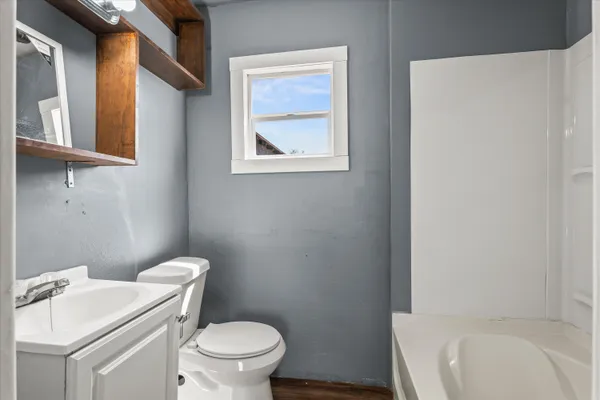 a white toilet sitting next to a white sink
