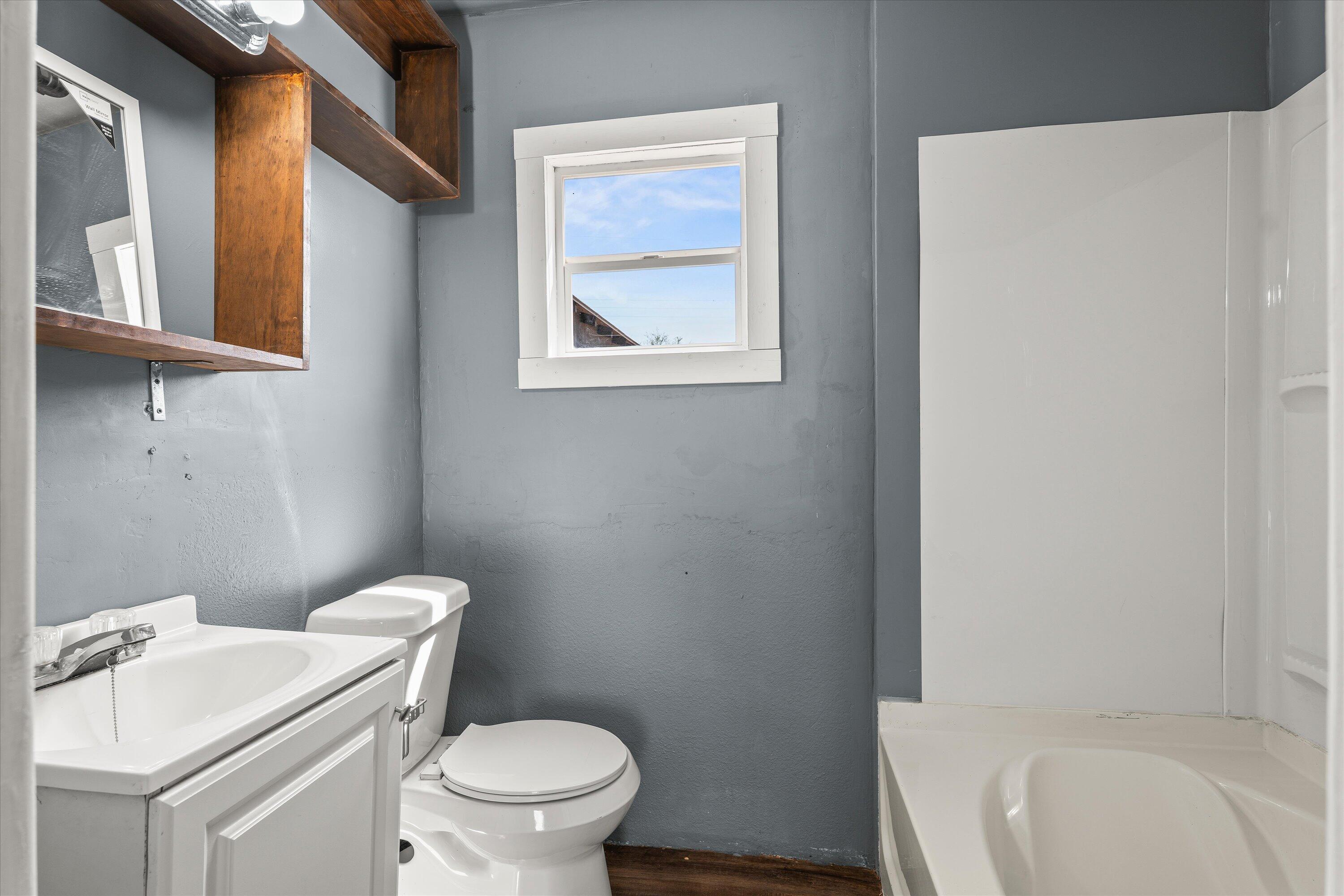 1848 8th Street Levelland, TX 79336 - Photo 5 of 6 a white toilet sitting next to a white sink