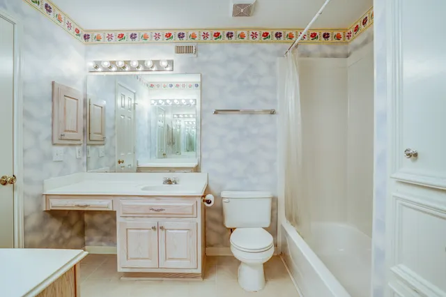a bathroom with a sink toilet tub and shower