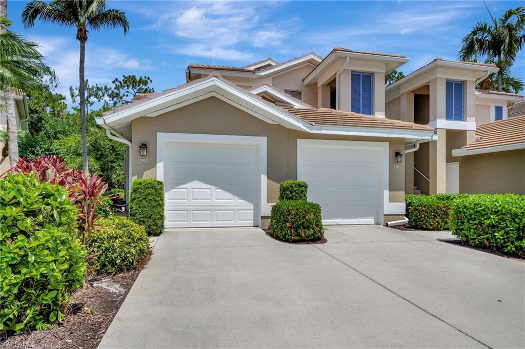 832 Carrick Bend Circle, Unit 101 Naples, FL 34110 - Photo 1 of 5 front view of house with potted plants