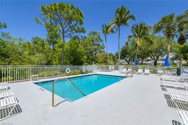 swimming pool view with a garden space