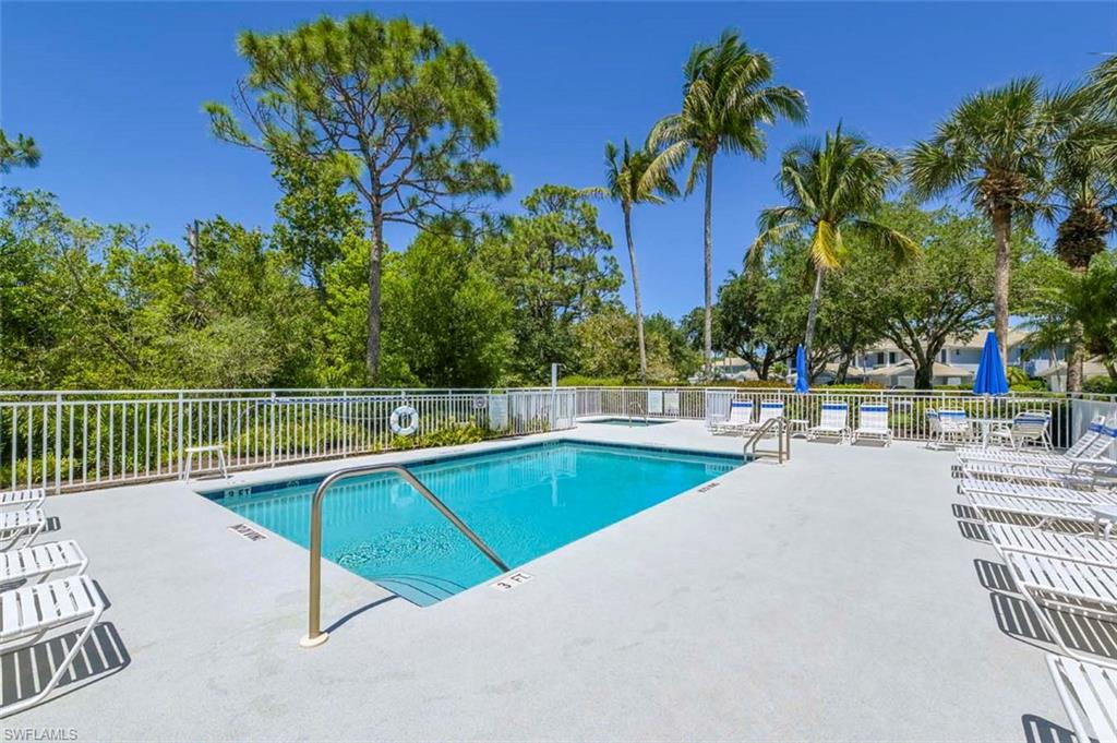 832 Carrick Bend Circle, Unit 101 Naples, FL 34110 - Photo 3 of 5 a view of a swimming pool with a lounge chair