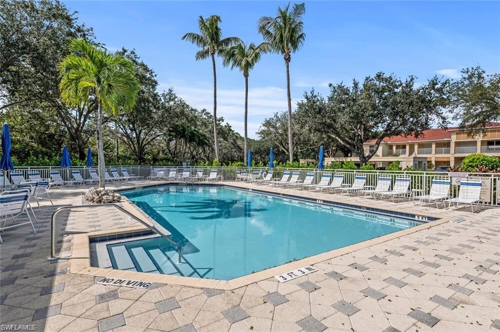 832 Carrick Bend Circle, Unit 101 Naples, FL 34110 - Photo 4 of 5 swimming pool view with a garden space