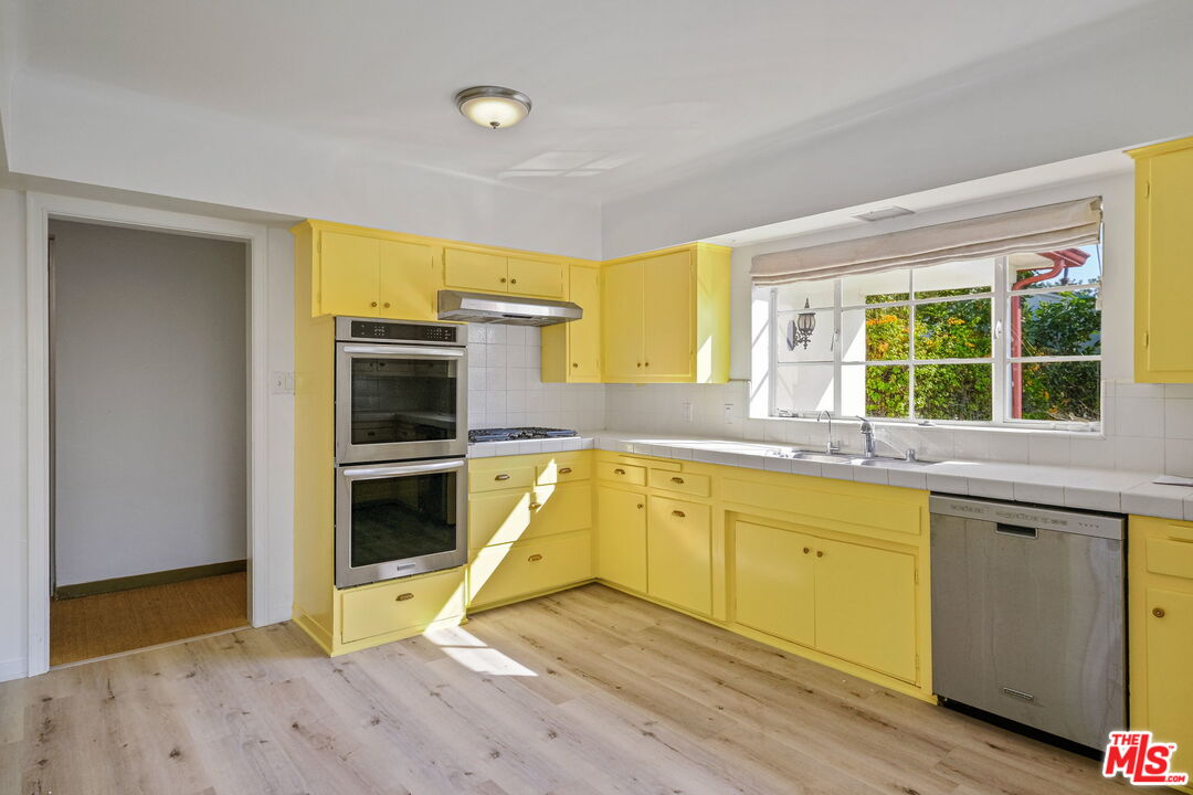 1968 Cummings Drive Los Angeles, CA 90027 - Photo 11 of 26 a kitchen with a sink wooden floor and stainless steel appliances