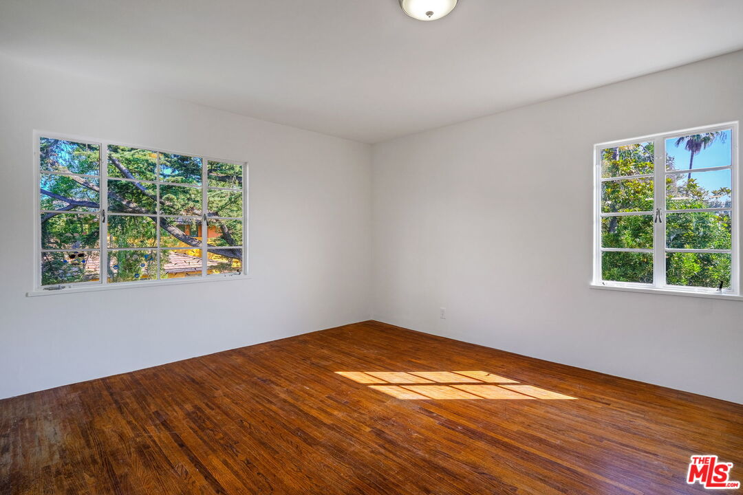 1968 Cummings Drive Los Angeles, CA 90027 - Photo 13 of 26 a view of empty room with wooden floor and fan