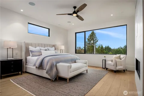 a spacious bedroom with a bed and glass window