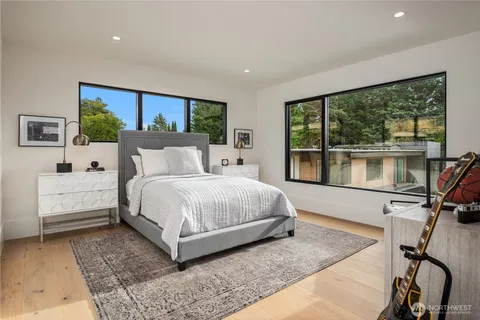 a bedroom with a bed and large window