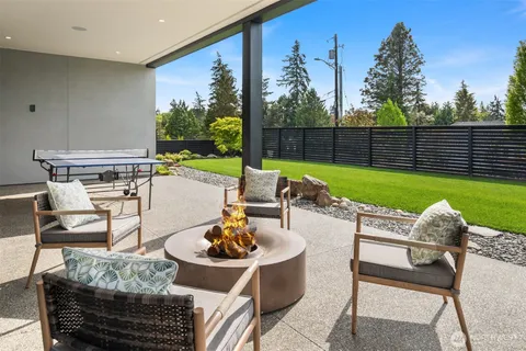 a view of a patio with couches table and chairs and potted plants