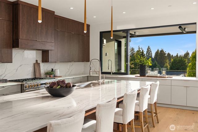 a kitchen with stainless steel appliances granite countertop a sink a stove and a refrigerator