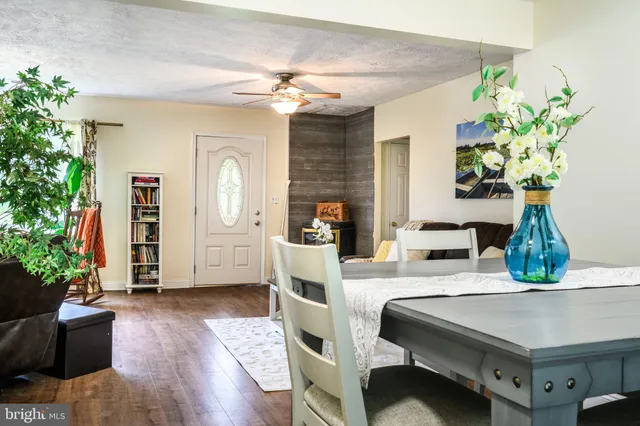 a dining room with furniture and wooden floor