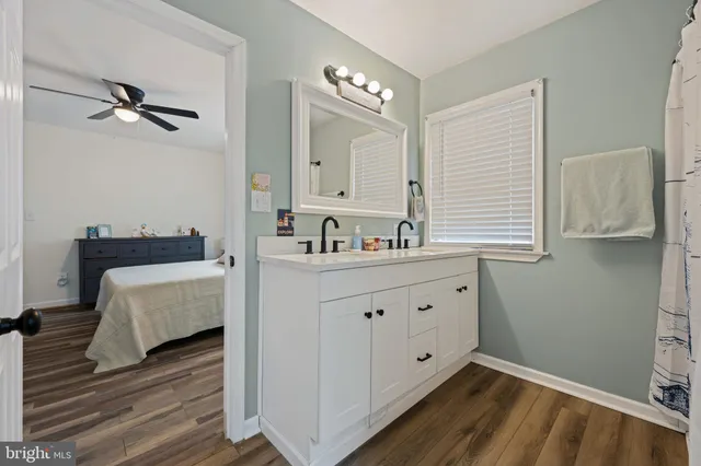 a spacious bathroom with a double vanity sink and a mirror