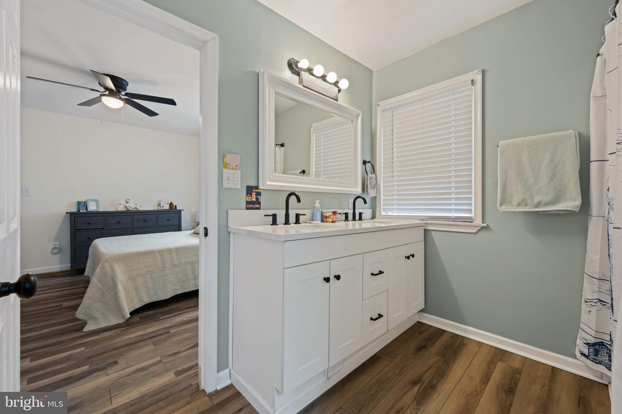204 Long Point Road Stevensville, MD 21666 - Photo 20 of 34 a spacious bathroom with a double vanity sink and a mirror