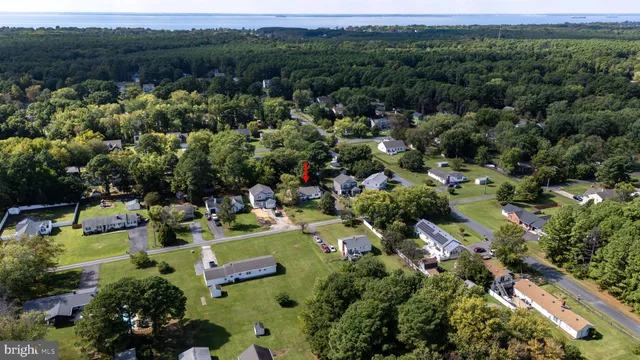 an aerial view of a houses with a yard