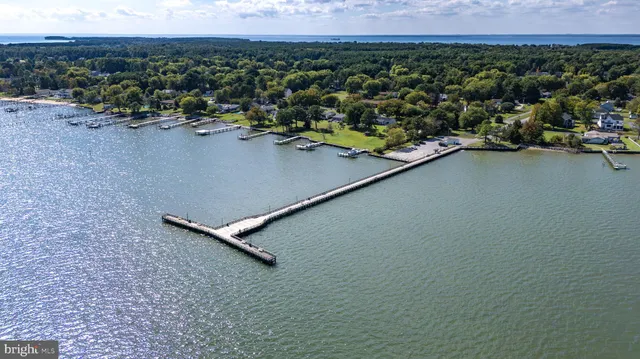 an aerial view of a house with a yard and lake view