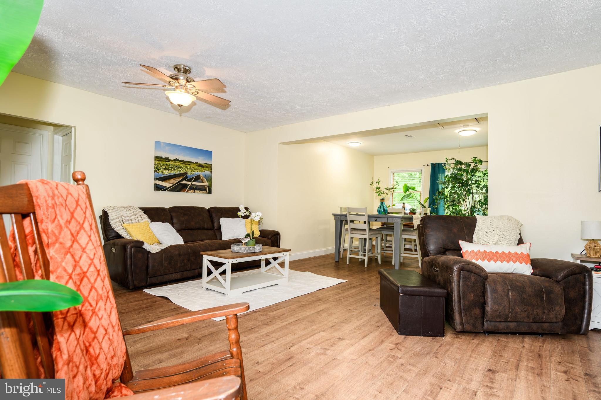 204 Long Point Road Stevensville, MD 21666 - Photo 9 of 34 a living room with furniture a chandelier and a dining table