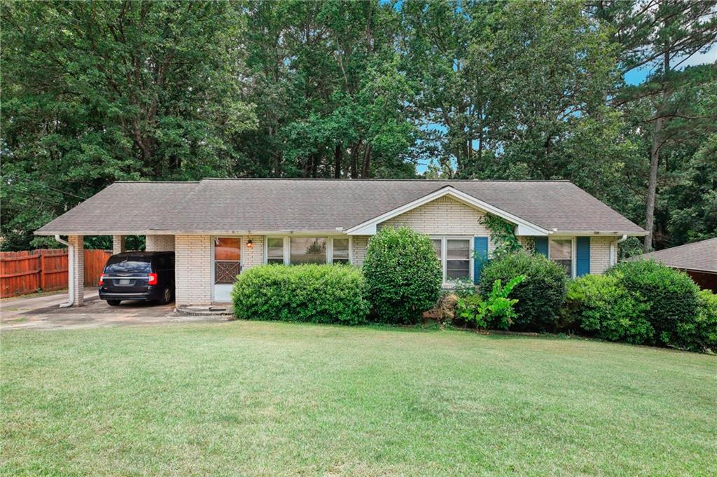 a house with lots of trees in the background
