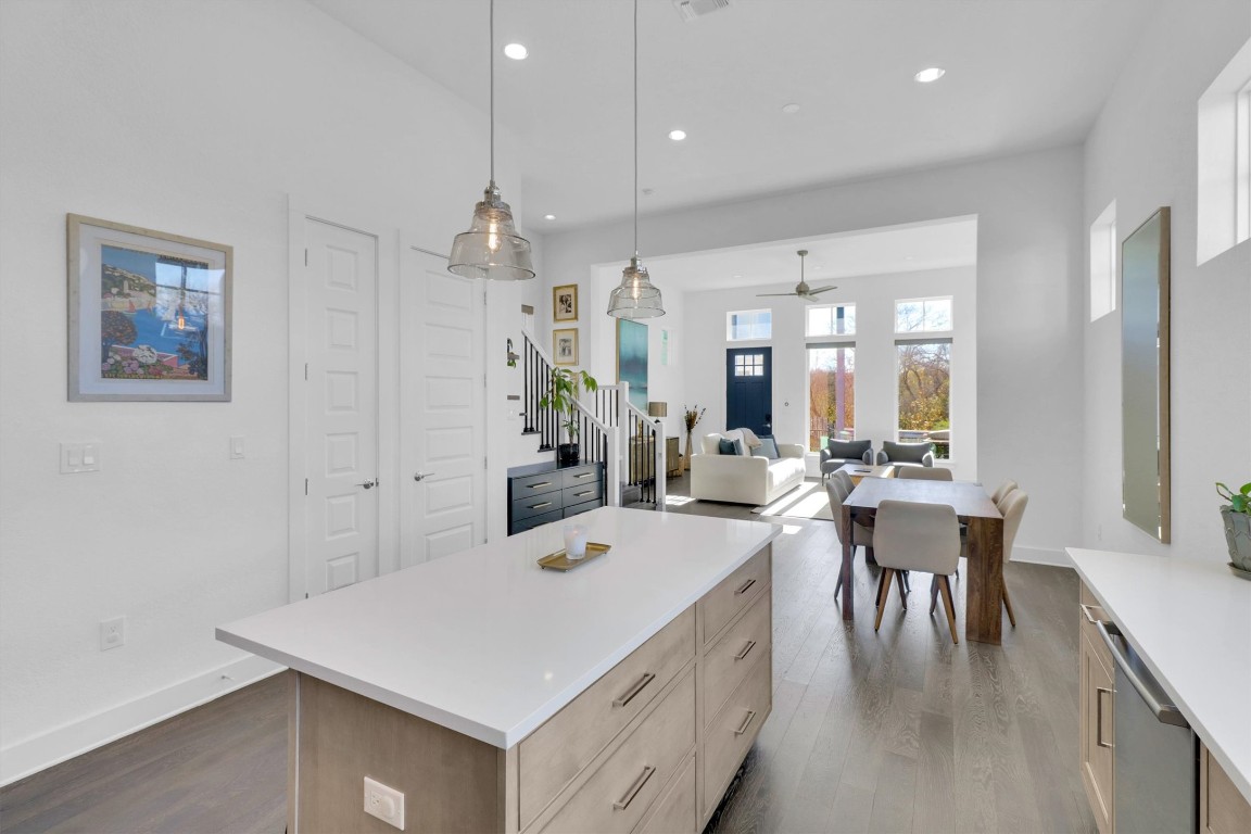 4806 Olive Sparrow Drive, Unit C Austin, TX 78723 - Photo 32 of 32 Kitchen with light brown cabinetry, a kitchen island, dark wood-type flooring, decorative light fixtures, and open floor plan