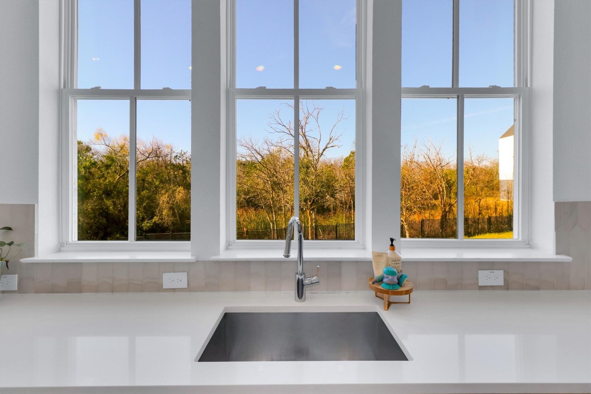 4806 Olive Sparrow Drive, Unit C Austin, TX 78723 - Photo 13 of 32 Kitchen view of a sink and light stone countertops