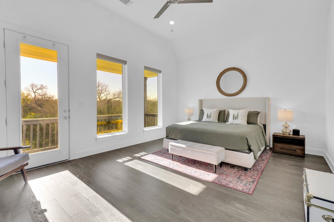 4806 Olive Sparrow Drive, Unit C Austin, TX 78723 - Photo 15 of 32 Bedroom with access to exterior, vaulted ceiling, wood finished floors, and ceiling fan