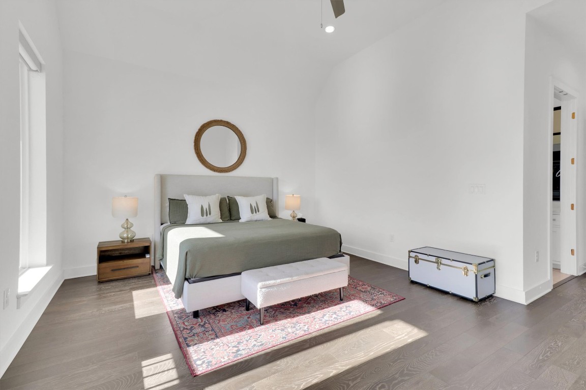 4806 Olive Sparrow Drive, Unit C Austin, TX 78723 - Photo 16 of 32 Bedroom with wood finished floors, a ceiling fan, and vaulted ceiling