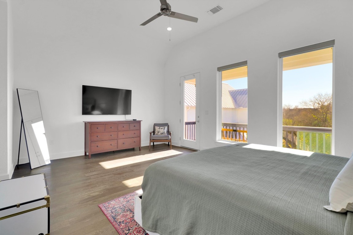 4806 Olive Sparrow Drive, Unit C Austin, TX 78723 - Photo 17 of 32 Bedroom with wood finished floors, ceiling fan, access to outside, vaulted ceiling, and recessed lighting