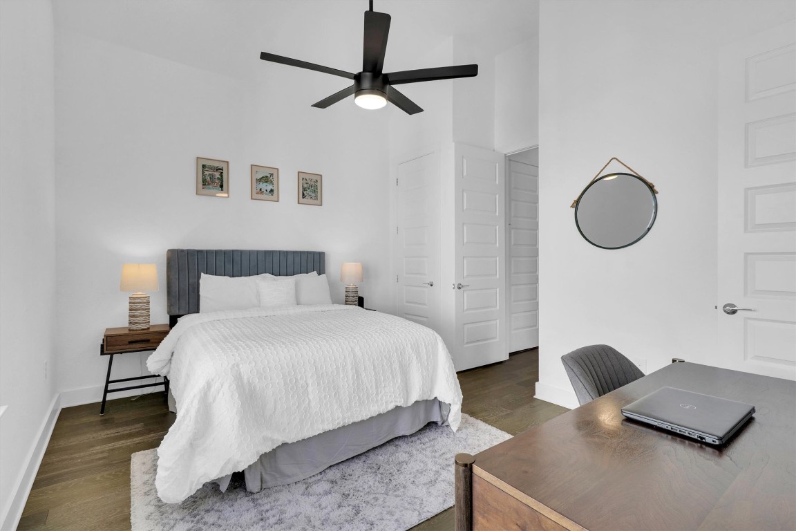 4806 Olive Sparrow Drive, Unit C Austin, TX 78723 - Photo 22 of 32 Bedroom with a high ceiling, a desk, wood finished floors, and a ceiling fan