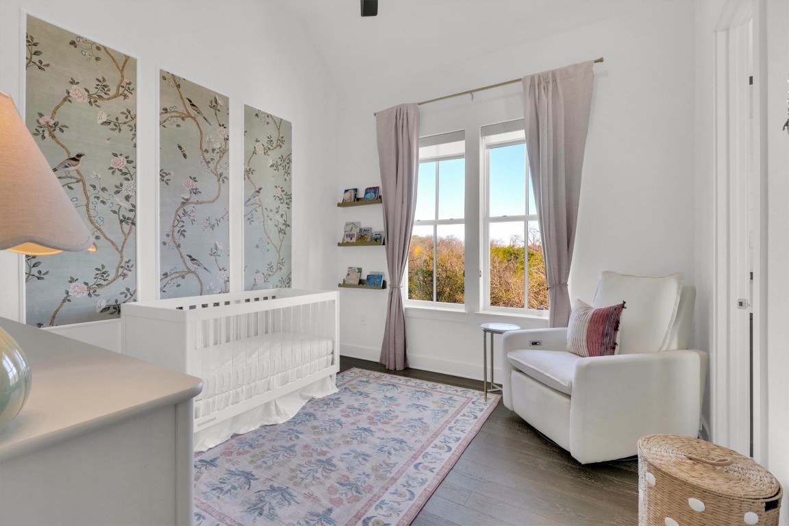 4806 Olive Sparrow Drive, Unit C Austin, TX 78723 - Photo 24 of 32 Bedroom with a nursery area, dark wood-type flooring, lofted ceiling, and a ceiling fan
