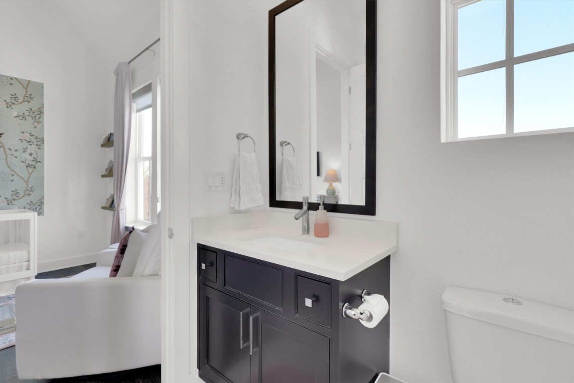 4806 Olive Sparrow Drive, Unit C Austin, TX 78723 - Photo 27 of 32 Half bathroom featuring vanity and toilet