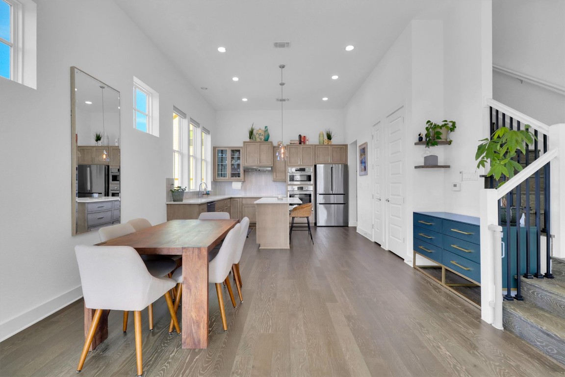 4806 Olive Sparrow Drive, Unit C Austin, TX 78723 - Photo 6 of 32 Dining room with recessed lighting, light wood-style flooring, stairway, and a towering ceiling