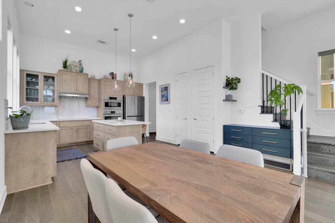 4806 Olive Sparrow Drive, Unit C Austin, TX 78723 - Photo 7 of 32 Dining space with a towering ceiling, recessed lighting, light wood-style flooring, and stairs