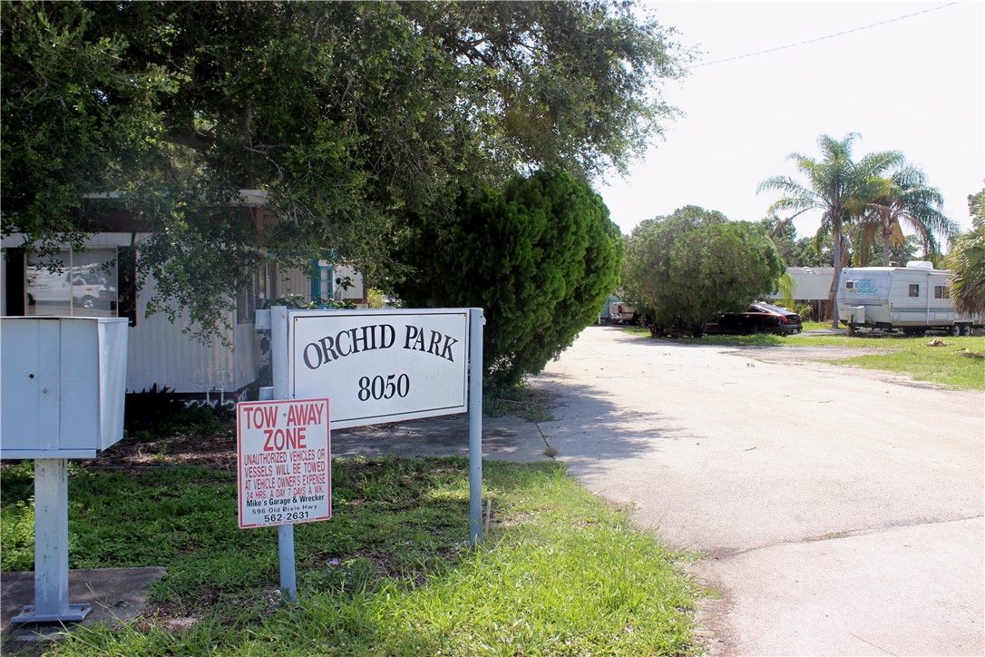 8050 Highway 1 Vero Beach, FL 32967 - Photo 2 of 16 a sign board with tall trees