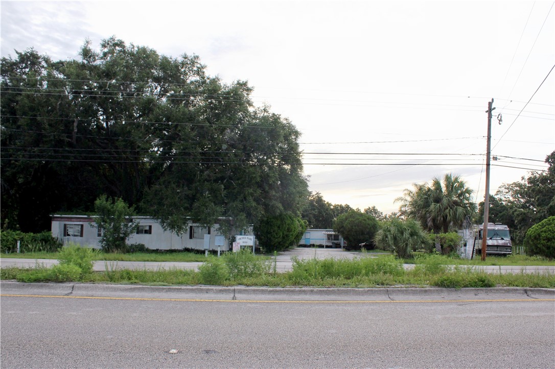 8050 Highway 1 Vero Beach, FL 32967 - Photo 5 of 16 a front view of a house with a yard and a more windows
