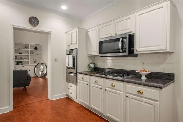 a kitchen with stainless steel appliances granite countertop a stove and a microwave