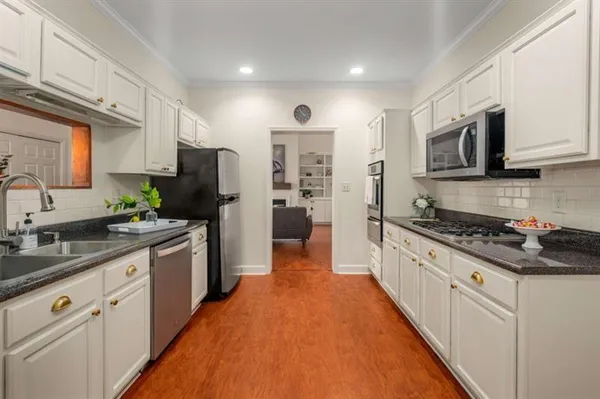 a large kitchen with stainless steel appliances granite countertop a stove refrigerator sink and dishwasher