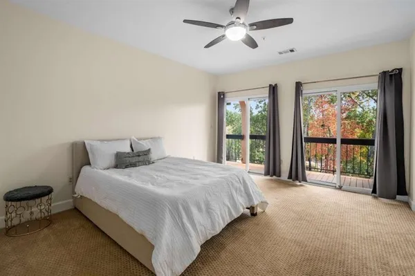 a large bed sitting in a bedroom next to a window