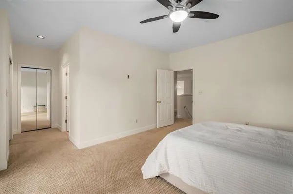 a bedroom with a bed and a ceiling fan
