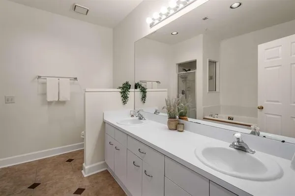 a bathroom with a double vanity sink and a mirror